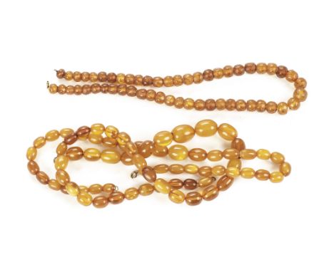Three vintage amber bead necklaces, including two with smooth graduating oval beads, the other with faceted beads (3)