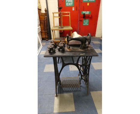 A Treadle Singer Sewing Machine and Pair of Vintage Roller Skates 