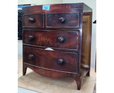 A 19th century mahogany apprentice chest of 2 long and 2 short drawers with bow front, bobbin handles etc ht. 38cm x length 3