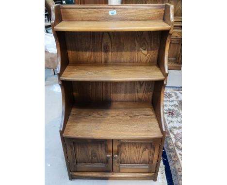 A modern Ercol medium elm 3 height bookcase with cupboard under 