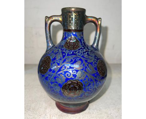 A Royal Lancastrian spherical 2 handled vase on circular foot, lustre decoration with red flowers against a blue ground, mono