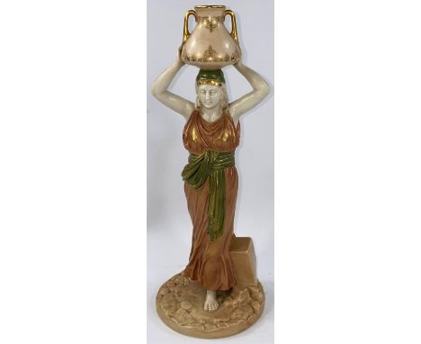 A late 19th/early 20th century Royal Worcester figure of a female water carrier, her arms holding a pitcher on her head, in m