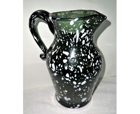 A 19th century Rock Wardine style green glass jug, ht. 21cm.&nbsp;Good condition, with some white enamel bursts noted.