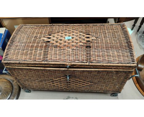 A wicker storage trunk with metal frame 