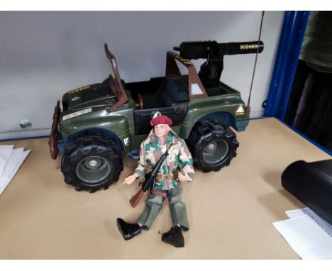 A vintage Action Man in full camo and a later Action Man vehicle 