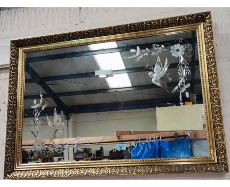 A gilt wall mirror etched with bird in a branch 