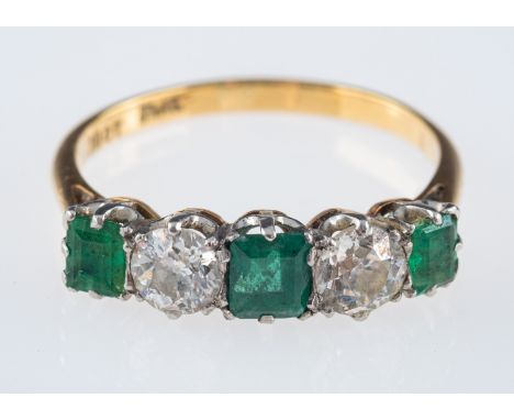 An emerald and diamond ring, the three square cut emeralds with old brilliant cut diamonds, approximately 0.50 carats total, 