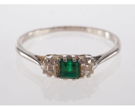 An emerald and diamond ring, the square cut emerald between two square cut diamonds, stamped platinum, ring size P 1/2