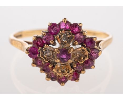 A 9ct gold, ruby and diamond cluster ring, set with circular cut rubies and eight cut diamonds, stamped 375 with Birmingham h