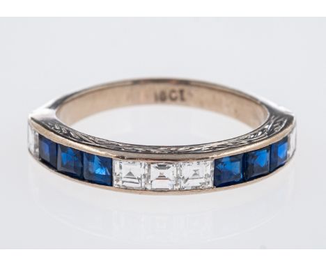 A sapphire & diamond set eternity ring, the square cut stones in 18ct white gold mount with engraved decoration, ring size J,