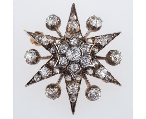 A Victorian diamond set star brooch, the six point star and rays set with old cut diamonds, set in gold and silver, central s