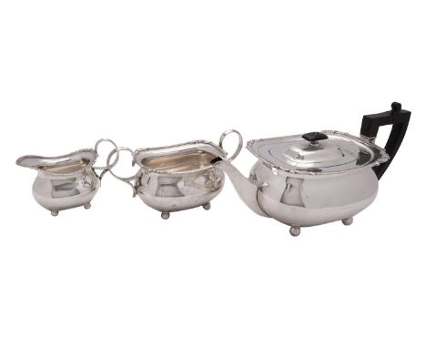 A matched Edwardian silver three piece tea service by William Hutton & Sons Ltd, London 1902 and 1903, oblong baluster, the t