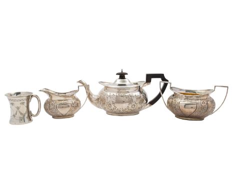 An Edwardian silver three piece tea service by James Deakin & Sons, Sheffield 1902, rounded oval, the tea pot with a composit