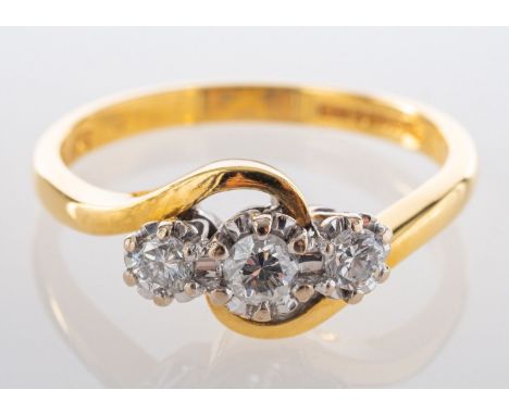 An 18ct gold, round, brilliant-cut diamond, three-stone, cross-over ring, total diamond weight stamped 0.33ct, H-I colour VS2