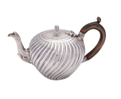 A Victorian silver tea pot by Charles Stuart Harris, London 1882, with a wrythen finial to the flat cover, a wooden scroll ha