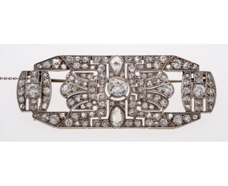 A 1930's diamond set brooch in fine millgrain setting, central round old cut stone of approximately 0.70 carats, two stones o