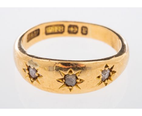 A Victorian gold ring with three small rose cut diamonds in gypsy setting, Birmingham 1898, ring size L , weight 4.8 grams   