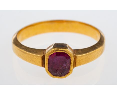 A ruby single stone ring in high carat gold, rub-over setting with closed back, weight 3.8 grams ring size j-K   Condition Re