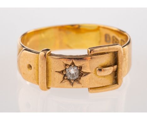 A gold and diamond buckle ring, the buckle ring set with an old cut diamond, stamped 18 with Chester hallmarks, ring size Q 1