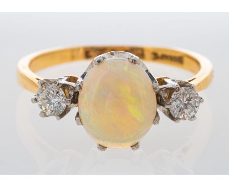An opal and diamond ring in yellow gold, total diamond weight estimated at 0.30 carat, ring size J   