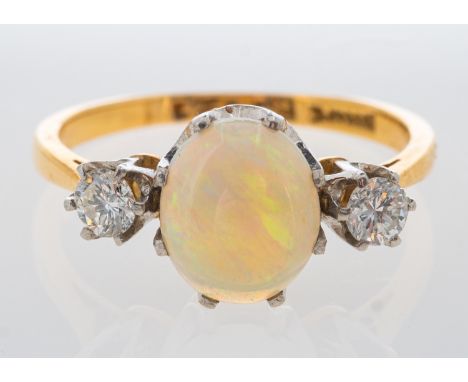 An opal and diamond ring in yellow gold, total diamond weight estimated at 0.30 carat, ring size J   