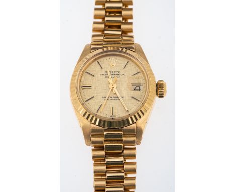 Rolex Oyster Datejust, a lady's 18ct gold wristwatch, model 6917, date J 1601, the gold bark design dial signed Rolex, Oyster