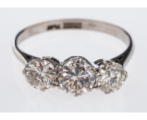 A three stone diamond ring, the principle brilliant cut diamond of approximately 1 carat, total diamond weight estimated at 2