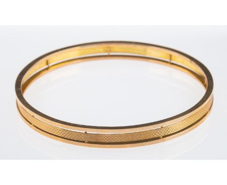 A 1920's flapper girl arm bangle, with three bands the central with engine turned decoration, 9ct    Condition Report  11.8 g