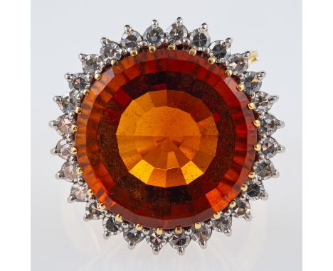 A Vintage Madeira citrine cocktail ring, the central stone of red to orange colour, within a border of diamonds, in sculptura