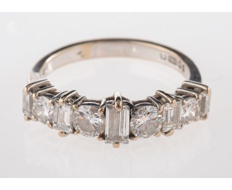 An 18ct gold and diamond ring, half set with alternating brilliant cut and baguette cut diamonds, approximately 1.20 carats t