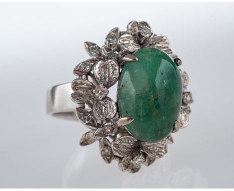 A Vintage jade and diamond cocktail ring, central jade cabouchon, in white gold floral mount with small diamonds, ring size L