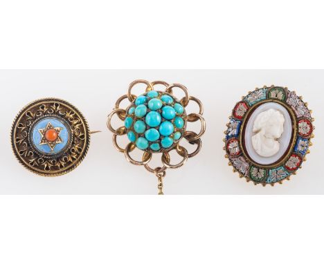 Three brooches, including a cabochon-cut turquoise brooch, with scalloped surround; an Etruscan Revival coral and blue enamel