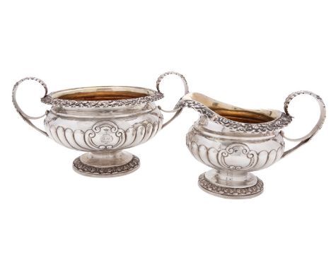 A George IV Scottish silver cream jug and sugar basin by Charles Bendy, Edinburgh 1822, with leaf-capped scroll handles, flow