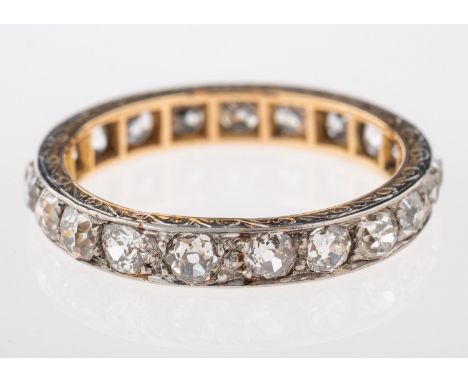 A diamond eternity ring, set with old cut diamonds, with an engraved border, ring size N