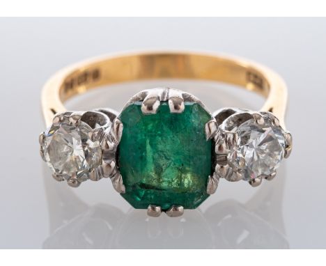 An 18ct gold, emerald-cut emerald and round, brilliant-cut diamond, three-stone ring, estimated emerald weight ca. 2.10cts, t