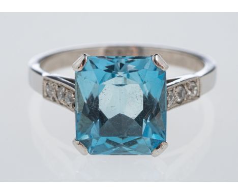 A platinum dress ring set with a mixed cut aquamarine, the shoulders set with small diamonds in millgrain setting, aquamarine