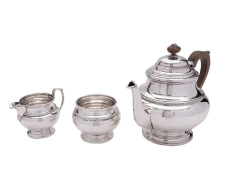 A silver three piece tea service by William Suckling Ltd, Birmingham 1930, baluster, the tea pot with a composition finial an