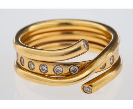 George Jensen a Magic ring combination of a gold band inset with brilliant cut diamonds and a crossover ring with diamond set