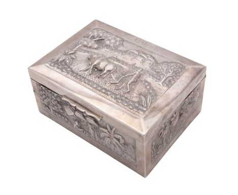 An Indian silver table box, unmarked, Calcutta late 19th century, rectangular and chased with scenes from rural life, initial