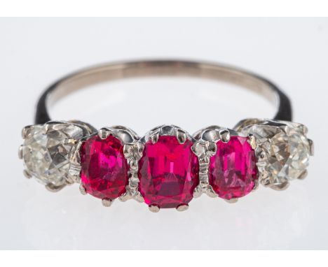 An Art Deco period, ruby and diamond ring, set with three rubies of good colour and two old cut diamonds, in platinum mount. 