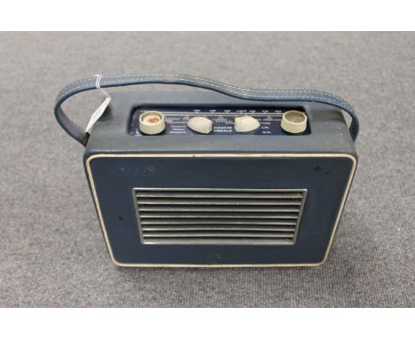 A vintage radio : Hacker Herald in blue case. 