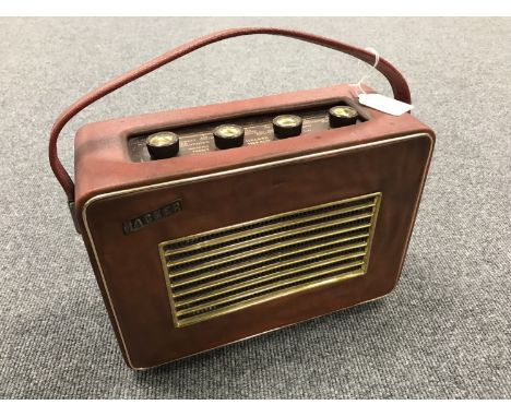 A vintage radio : Hacker Herald, in a red case. 