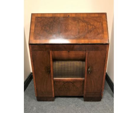 An early 20th century HMV radio turn table bureau, with integrated speaker and storage. 