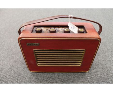 A vintage radio : Hacker Herald in a red case. 