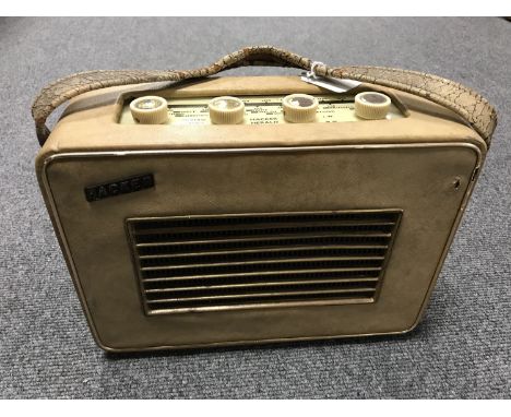 A vintage radio : Hacker Herald in a cream case. 