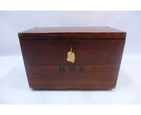A mahogany metal bound trunk with initials BWS with hinged lid and key raised on bun feet, H 46 x W 67 x D 34cm 