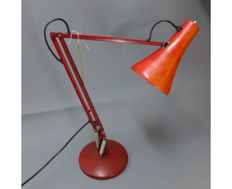 A retro angle poise lamp raised on circular base, H 84cm 