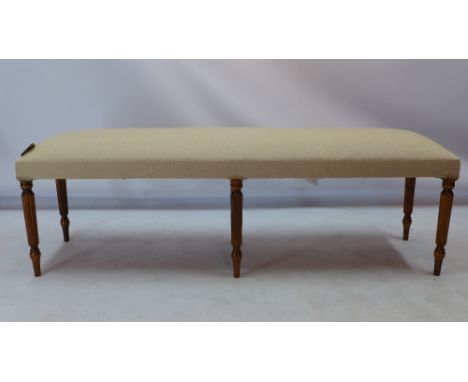 A Victorian style double window seat raised on six reeded and turned legs, H 46 x W 150 x D 43cm 