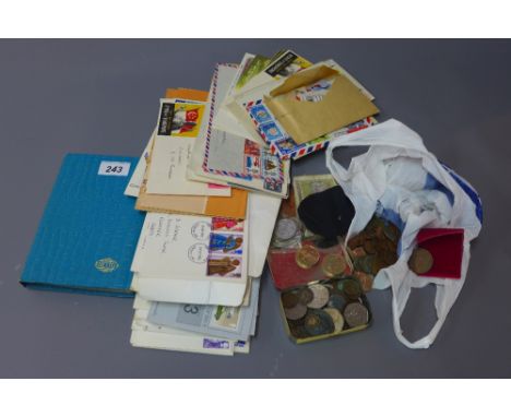 A collection of first day covers, a stamp book containing approximately 30 stamps, together with various coins and notes 