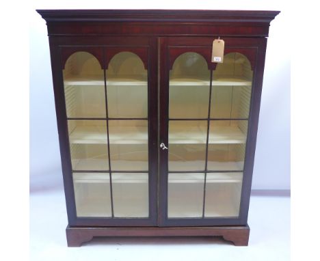 A 19th century mahogany bookcase with two astral glazed doors and raised on carved bracket feet, H 147 x W 125 x D 39cm 
